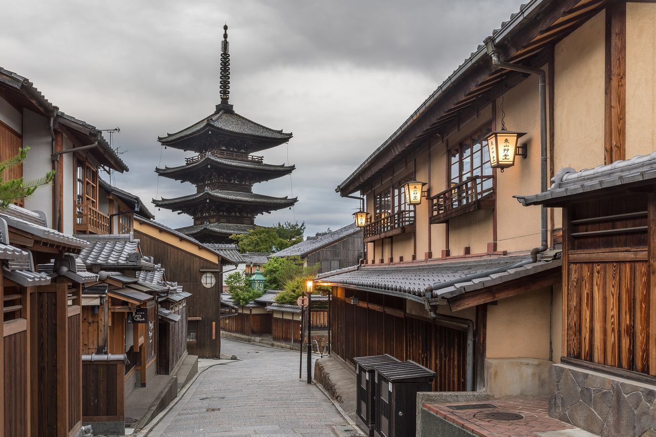 Pagoden Yasaka no Tō reser sig över en stilla gata med traditionella trähus och lyktor i Kyoto tidigt på morgonen